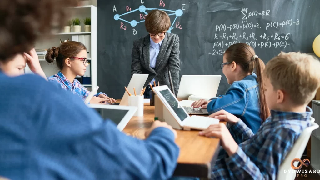 A teacher guides students using digital devices and data-driven tools in a modern classroom, showcasing cutting-edge resources for education.