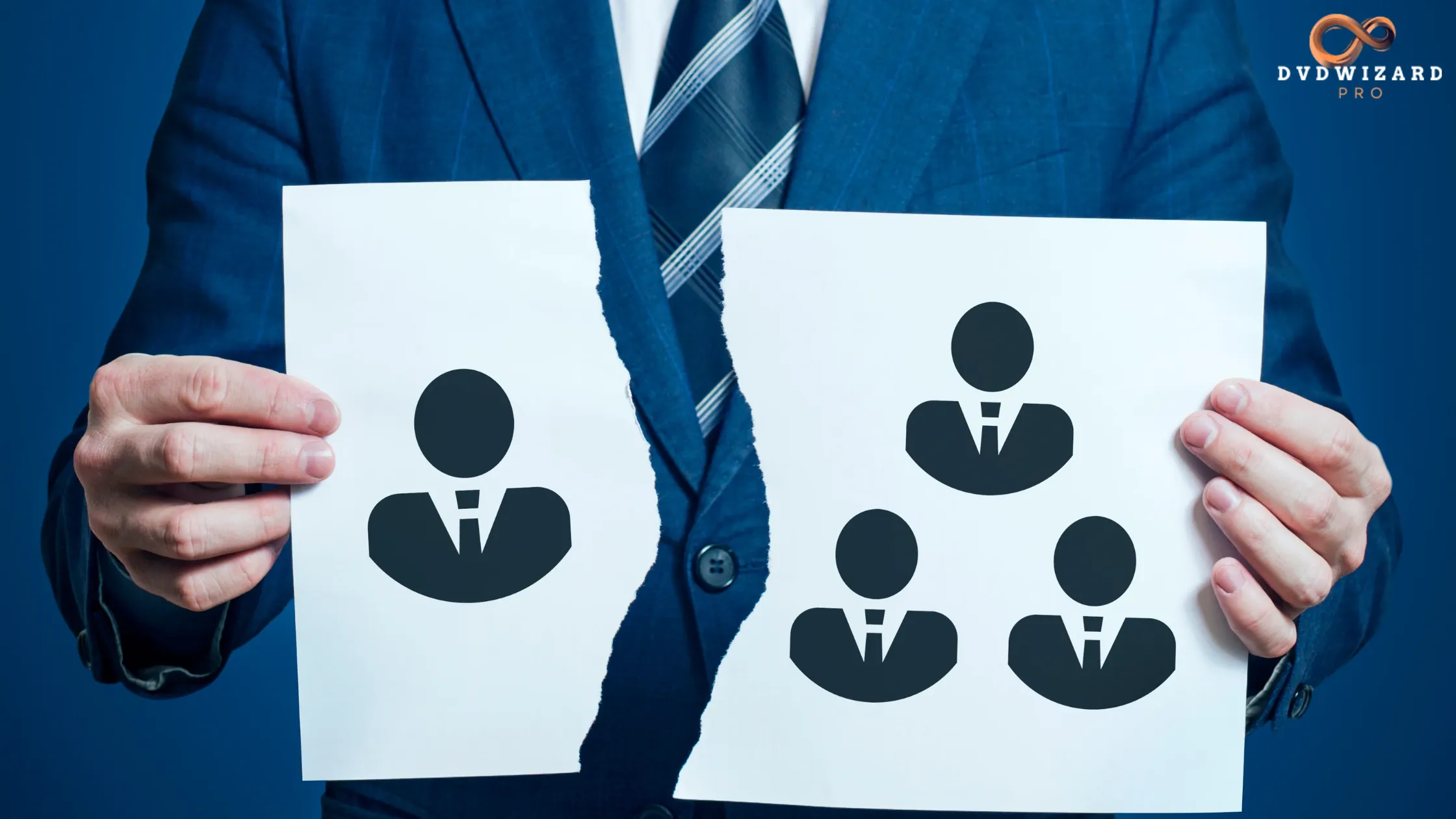 A businessman holding torn paper representing the breakup of a partnership or team.