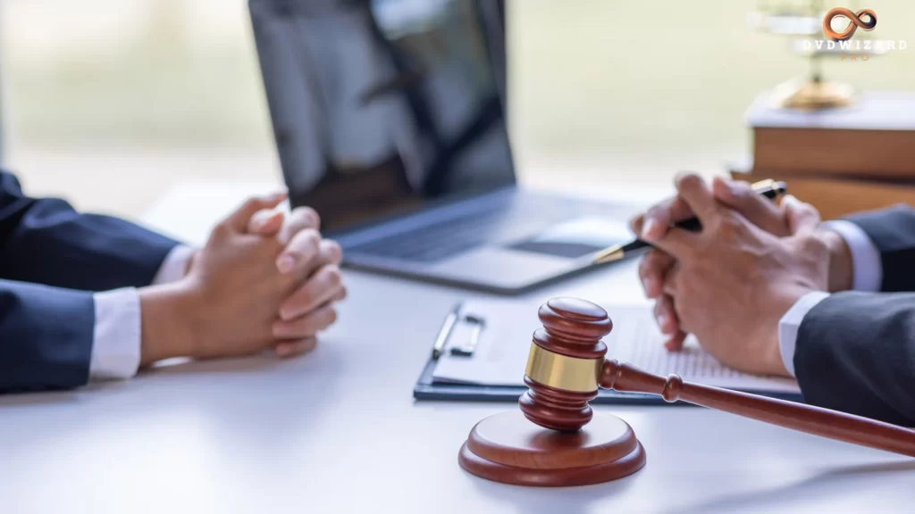 Two business professionals discussing legal matters with a gavel on the desk.